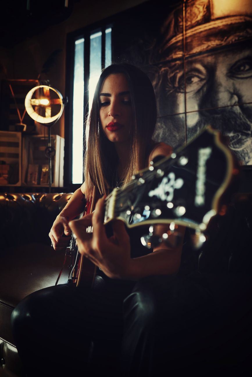 a woman playing the electric guitar