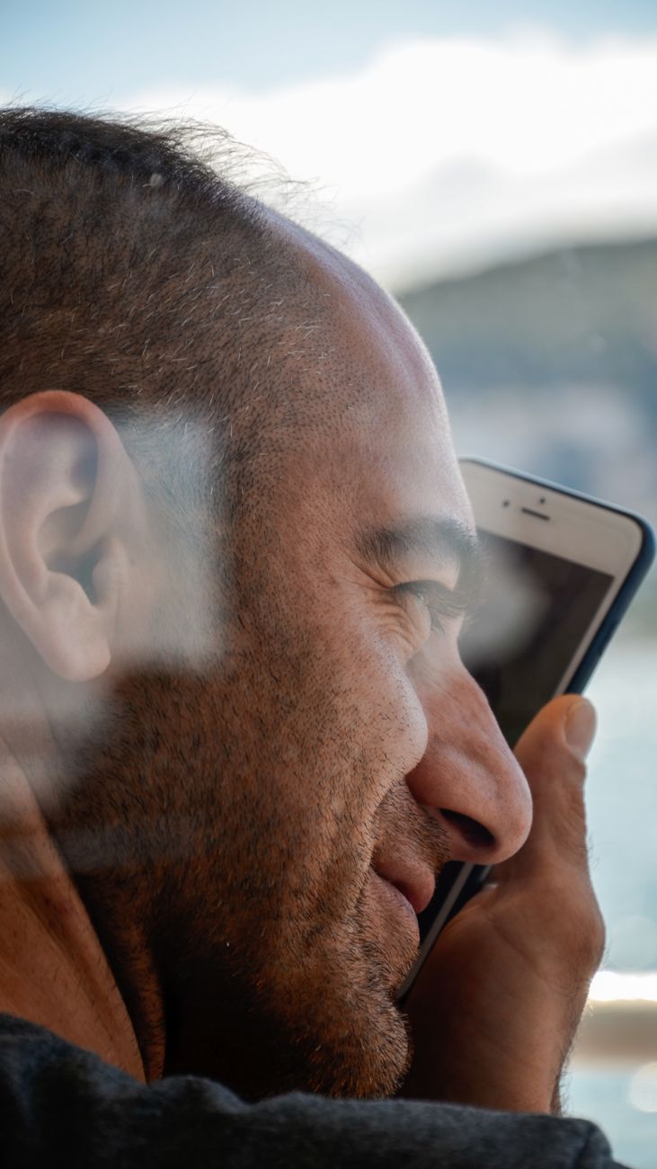 close up photo of a man holding cellphone
